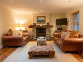 A living room with sofas and a fireplace at The Old Barn in Manchester