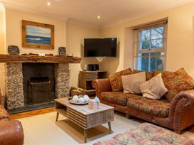 A living room with a fireplace and a television at The Old Barn in Manchester