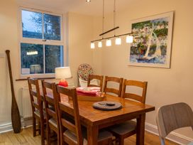 A dining room with wooden table and chairs at The Old Barn in Manchester