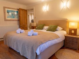 A bedroom with a bed and artwork at The Old Barn in Manchester