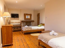 A bedroom with two beds and a television at The Old Barn in Manchester