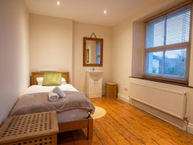 A bedroom with a bed and a sink at the property in a location