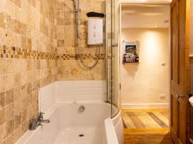 A bathroom with a bathtub and shower at The Old Barn in Manchester