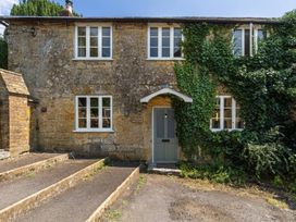 A house with ivy and a front door at The Old Cottage in an unspecified location