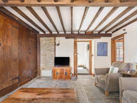 A living room with a television and armchair at the property