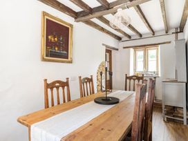 A dining room with a wooden table and chairs at The Old Barn in Manchester