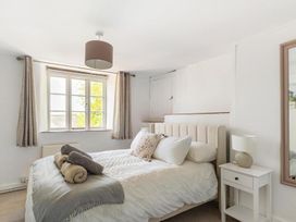 A bedroom with a bed and bedside table at The Old Barn in Manchester