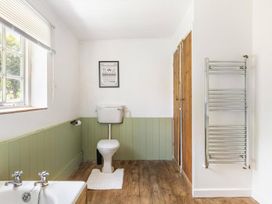 A bathroom with a toilet and sink at the property