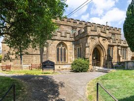 A church building with a stone entrance and seating area at a church in an outdoor location