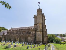 A church building with a tower and graveyard at an unspecified location