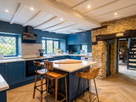 A kitchen with blue cabinets and a central island at The Old Barn in Manchester