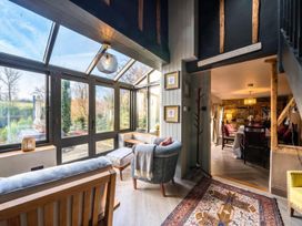 A conservatory with seating and dining area at The Old Barn in Manchester
