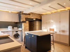 A kitchen with an island and washing machine at The Old Barn in Manchester