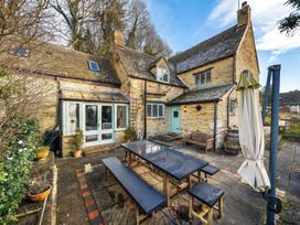 An outdoor dining area with a table and chairs at a house