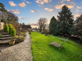 A garden with a lawn, pathway, and sun loungers at unspecified property