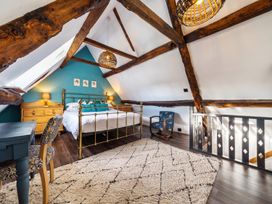A bedroom with a bed and dresser at The Old Barn in Manchester