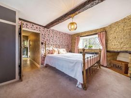 A bedroom with a bed and window at The Old Barn in Manchester
