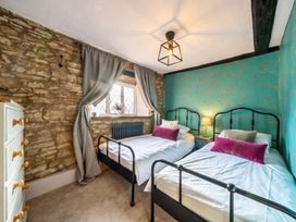 A bedroom with two beds and a window at The Old Barn in Manchester