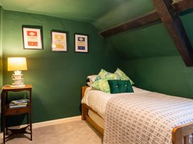 A bedroom with a bed and side table at  