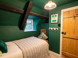 A bedroom with a bed and window at The Old Barn in Manchester