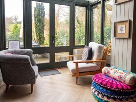 A conservatory with furniture and windows at 