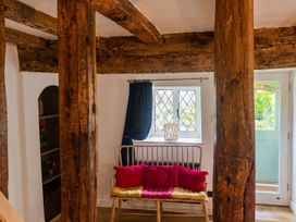 A living room with wooden beams and a sitting bench at the property