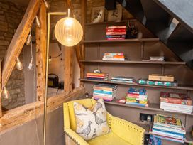 A reading nook with bookshelves and an armchair at the property