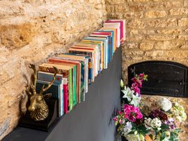 A bookshelf with books and a deer sculpture in a living room