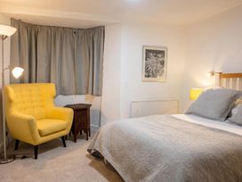A bedroom with a bed and armchair at 