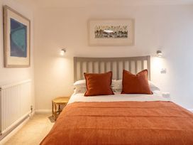 A bedroom with a bed and wall art at The Old Barn in Manchester