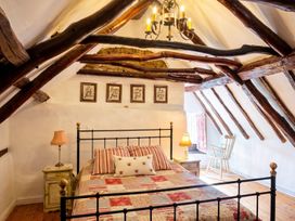 A bedroom with a bed and bedside table at The Old Barn in Manchester