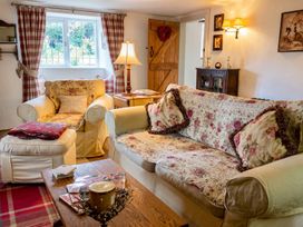A living room with a sofa and armchair at The Old Barn in Manchester