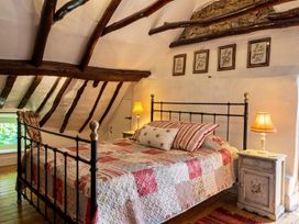 A bedroom with a metal bed and nightstand at The Old Barn in Manchester