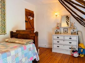 A bedroom with a bed and dresser at The Old Barn in Manchester