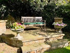 A bench with planters on either side at a garden