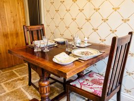 A dining table set with plates and glassware at a dining room