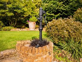 A garden with a water pump and flower pot at property in location 