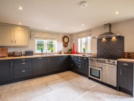 A kitchen with cabinets, sink, and oven at a property