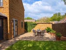 A garden with a stone wall and outdoor furniture at The Old Barn in Manchester