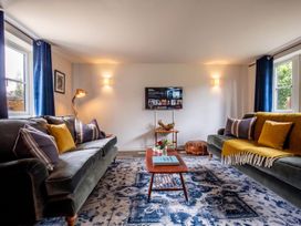 A living room with a TV and coffee table at the property