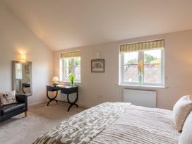 A bedroom with a bed and desk at The Old Barn in Manchester