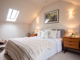 A bedroom with a bed and nightstands at The Old Barn in Manchester