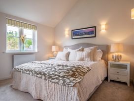 A bedroom with a bed and bedside tables at The Old Barn in Manchester
