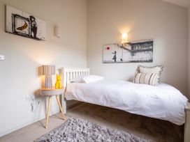 A bedroom with a bed and artwork on the wall at the property in the location