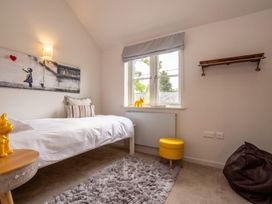 A bedroom with a bed and wall art at The Old Barn in Manchester