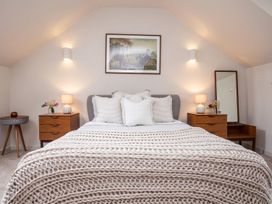 A bedroom with a bed, nightstands, and a mirror at 