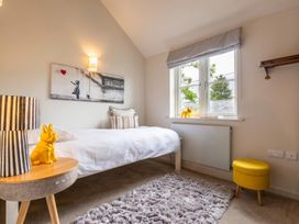 A bedroom with a bed and artwork on the wall at The Old Barn in Manchester