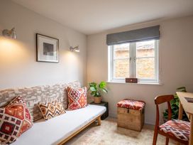 A living room with a sofa and a window at the property in 