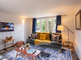 A living room with a sofa and television at The Old Barn in Manchester
