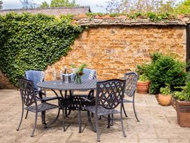 A table with chairs and plants in a garden setting at The Old Barn in Manchester